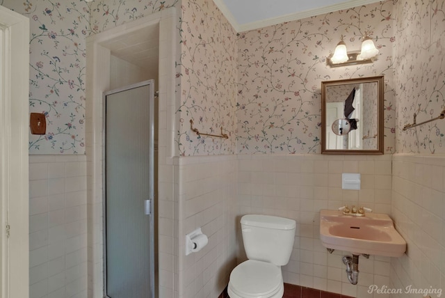 bathroom featuring toilet, sink, and a shower with shower door