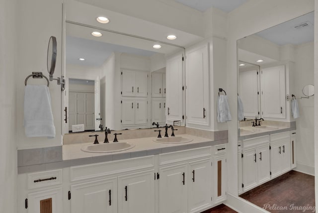 bathroom with hardwood / wood-style flooring and vanity