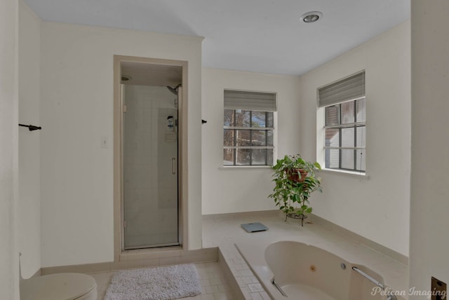 bathroom featuring toilet, tile patterned floors, and plus walk in shower