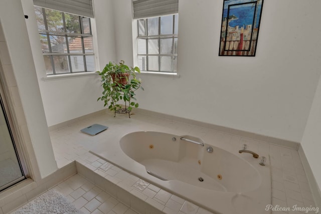 bathroom featuring a relaxing tiled tub