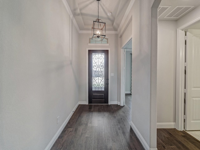 foyer entrance with ornamental molding and dark hardwood / wood-style flooring