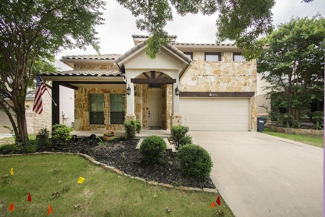 mediterranean / spanish home with a garage and a front yard