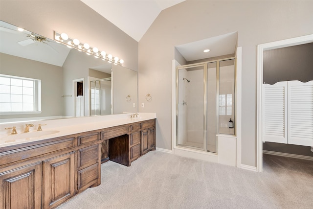 bathroom featuring an enclosed shower, vanity, vaulted ceiling, and ceiling fan