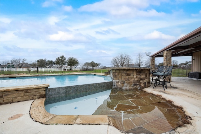 view of pool with a patio and an outdoor bar