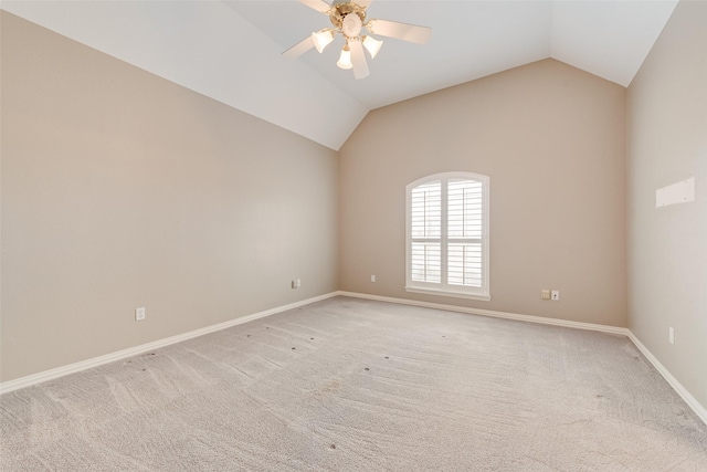 empty room featuring vaulted ceiling, light colored carpet, and ceiling fan