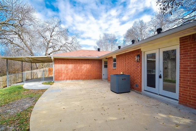 rear view of house featuring central AC, a patio area, and french doors