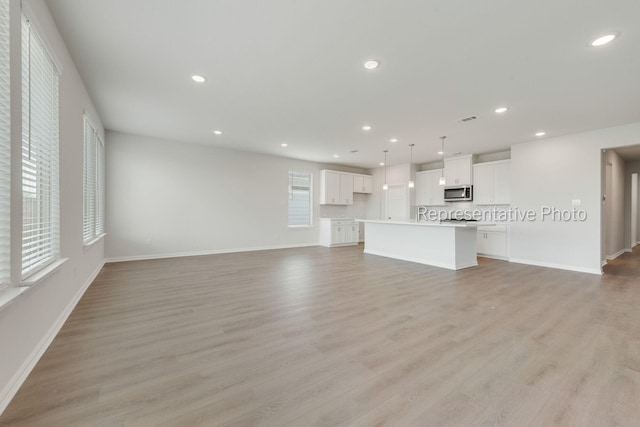 unfurnished living room featuring light hardwood / wood-style floors