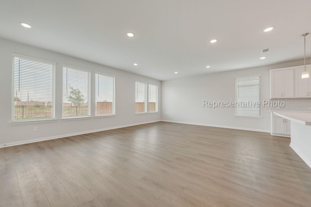 unfurnished living room featuring light hardwood / wood-style floors