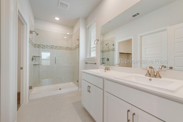 bathroom featuring vanity, an enclosed shower, and tile patterned flooring