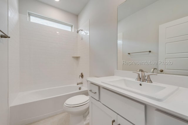 full bathroom featuring tiled shower / bath, vanity, and toilet