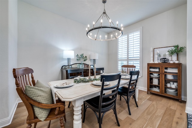 dining space featuring an inviting chandelier and light wood-type flooring