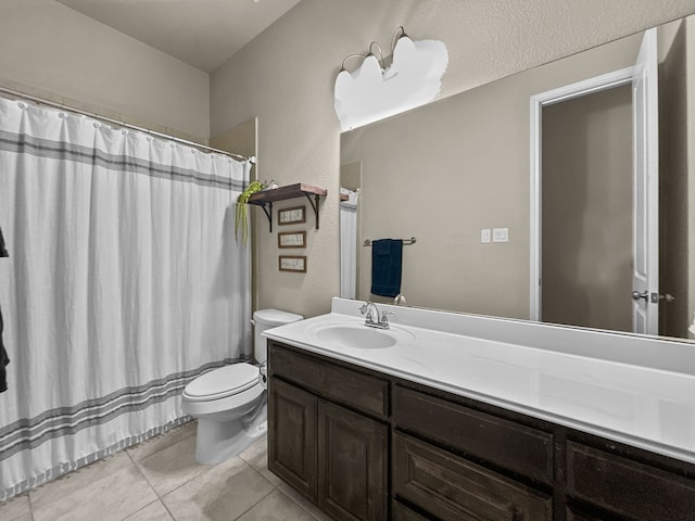 bathroom featuring tile patterned flooring, vanity, and toilet