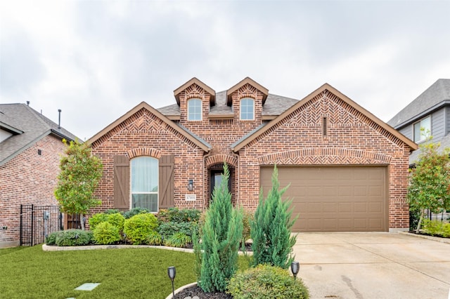 view of property with a garage and a front yard