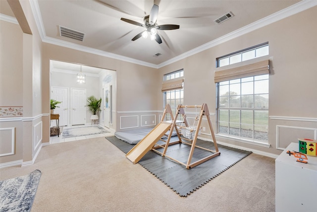 game room with crown molding, carpet, and ceiling fan