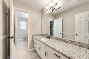 bathroom with vanity and toilet