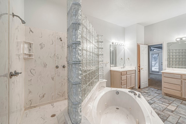 full bathroom with a tub with jets, a shower, and vanity