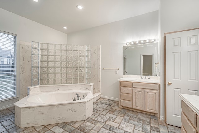 bathroom with recessed lighting, a healthy amount of sunlight, vanity, and baseboards