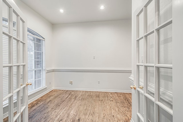 spacious closet with french doors and wood finished floors