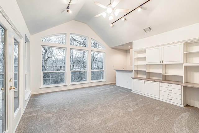 4781 Joe Wilson Rd, Midlothian, TX 76065 - unfurnished living room with track lighting, vaulted ceiling, light carpet, baseboards, and ceiling fan