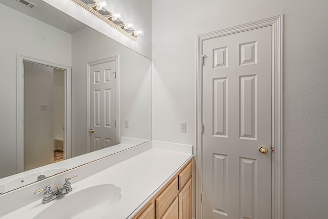 bathroom featuring visible vents and vanity