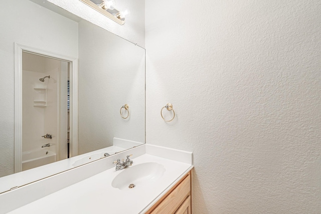 4781 Joe Wilson Rd, Midlothian, TX 76065 - bathroom featuring vanity, a textured wall, and tub / shower combination