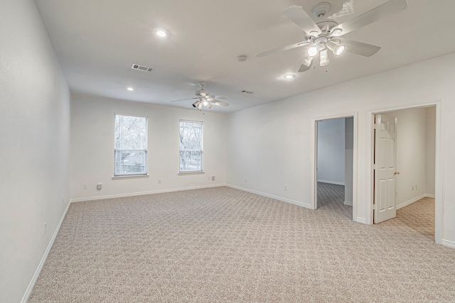 empty room featuring recessed lighting, visible vents, a ceiling fan, light carpet, and baseboards