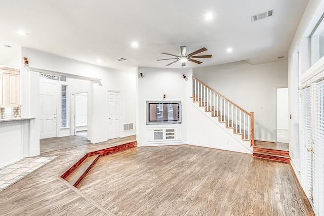 4781 Joe Wilson Rd, Midlothian, TX 76065 - unfurnished living room featuring ceiling fan, stairs, wood finished floors, recessed lighting, and baseboards