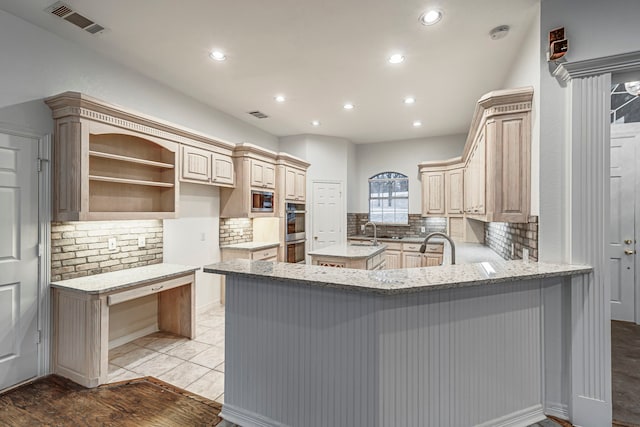 kitchen with a peninsula, stainless steel appliances, a kitchen island, visible vents, and open shelves