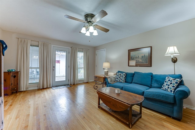 living room featuring light hardwood / wood-style flooring and ceiling fan