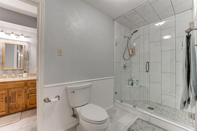 bathroom featuring vanity, an enclosed shower, and toilet