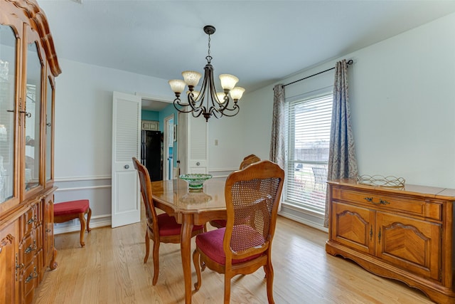 dining room featuring an inviting chandelier and light hardwood / wood-style flooring