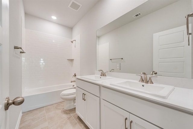 full bathroom featuring vanity, toilet, tiled shower / bath combo, and tile patterned flooring