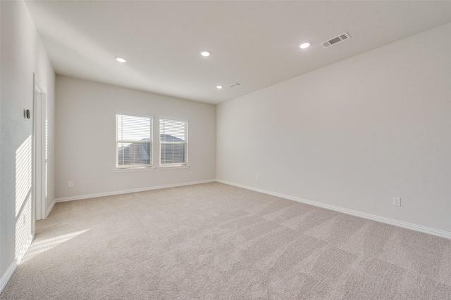 unfurnished room featuring light colored carpet