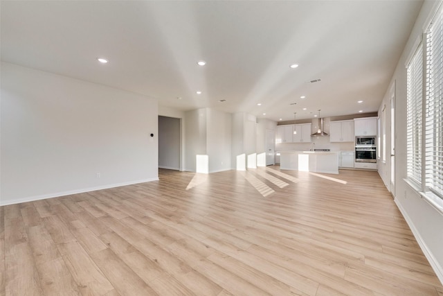 unfurnished living room with light wood-type flooring