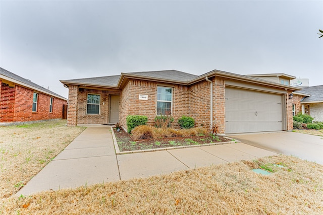 ranch-style home with roof with shingles, concrete driveway, an attached garage, and brick siding