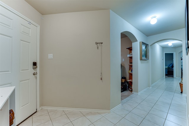 corridor with light tile patterned floors