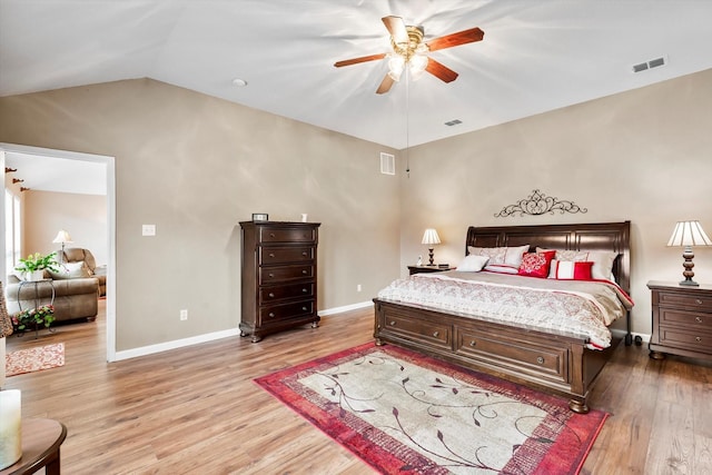 bedroom featuring wood-type flooring, vaulted ceiling, and ceiling fan