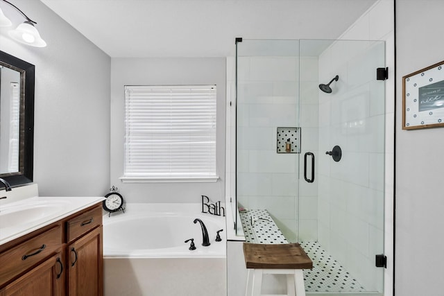 bathroom with vanity and shower with separate bathtub