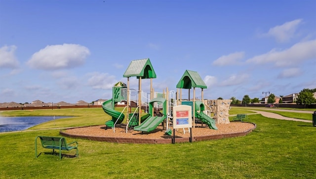 view of play area featuring a yard and a water view