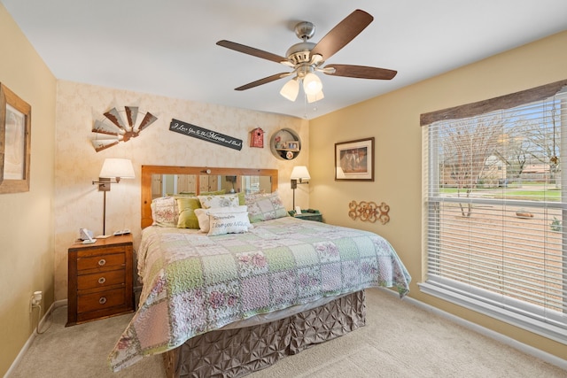 bedroom with ceiling fan and light colored carpet