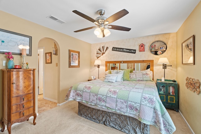 bedroom featuring light colored carpet and ceiling fan