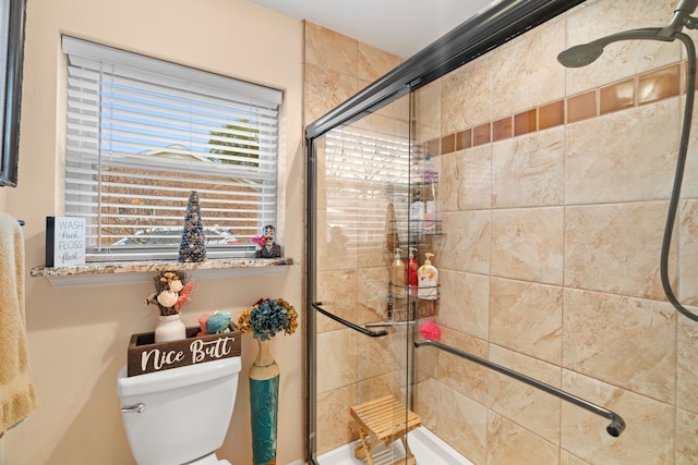 bathroom with toilet and walk in shower