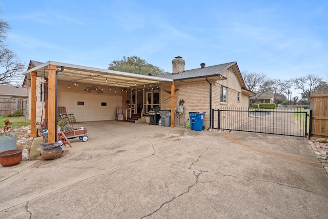 rear view of house featuring a carport and a garage