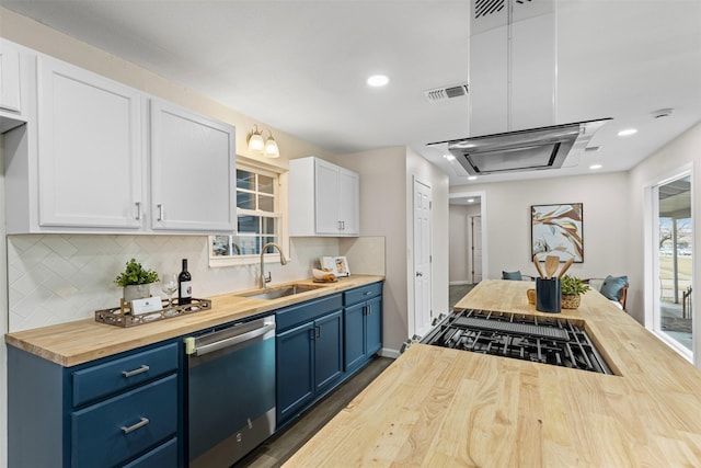 kitchen with wood counters, blue cabinets, sink, white cabinetry, and stainless steel dishwasher