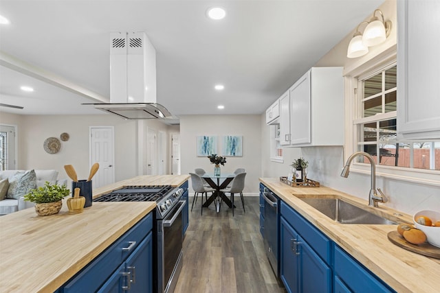 kitchen featuring extractor fan, sink, white cabinets, stainless steel appliances, and blue cabinetry