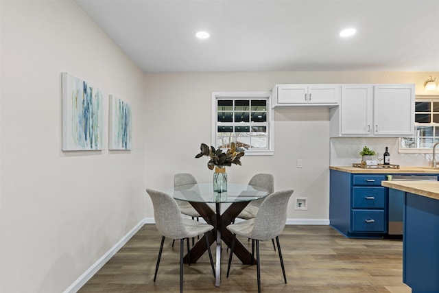 dining area with wood-type flooring and sink