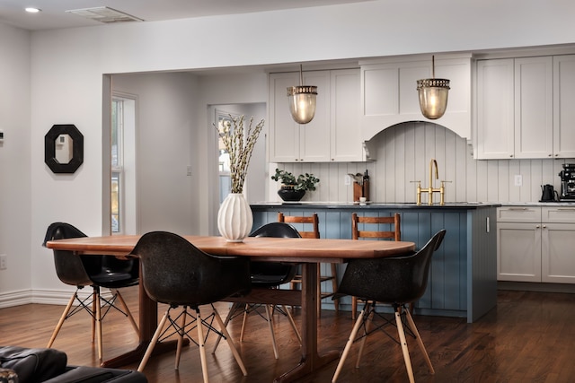 dining room with sink and dark hardwood / wood-style flooring