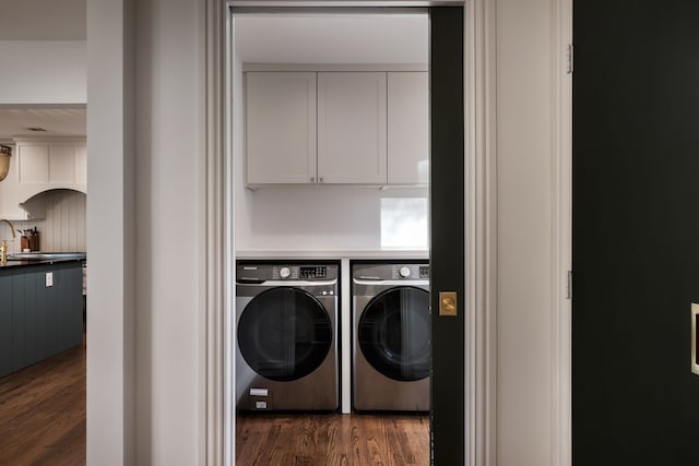 laundry room with dark wood-type flooring and washing machine and dryer