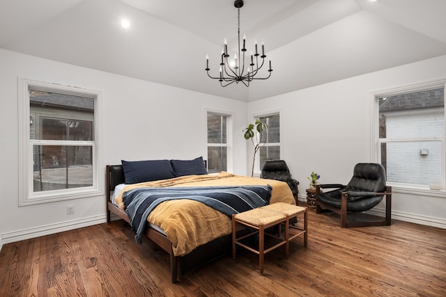 bedroom with a chandelier, vaulted ceiling, and hardwood / wood-style floors