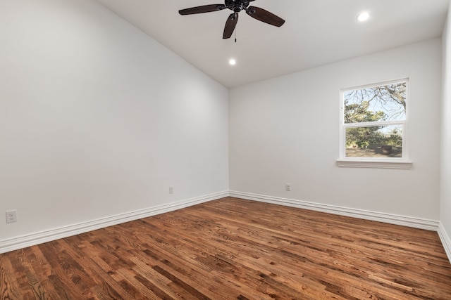 spare room with lofted ceiling, wood-type flooring, and ceiling fan